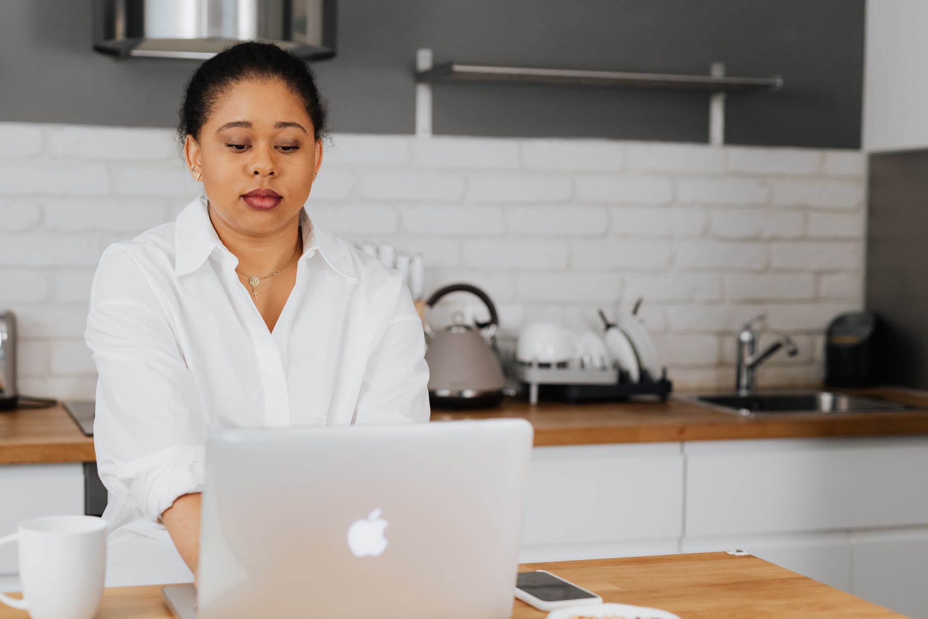 A homeowner reviewing a detailed renovation estimate on a laptop before approving it.