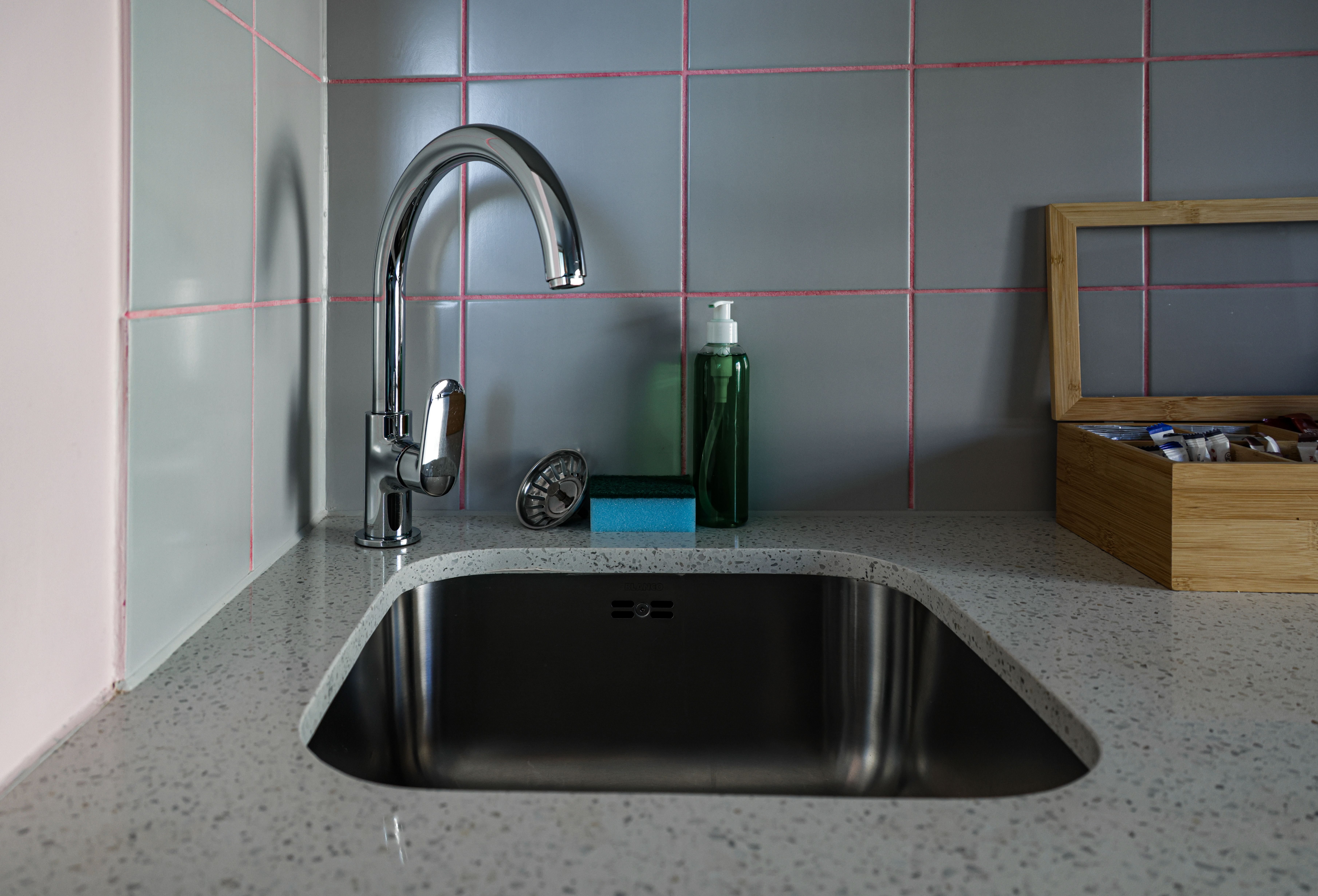 Chrome kitchen faucet above a stainless steel sink