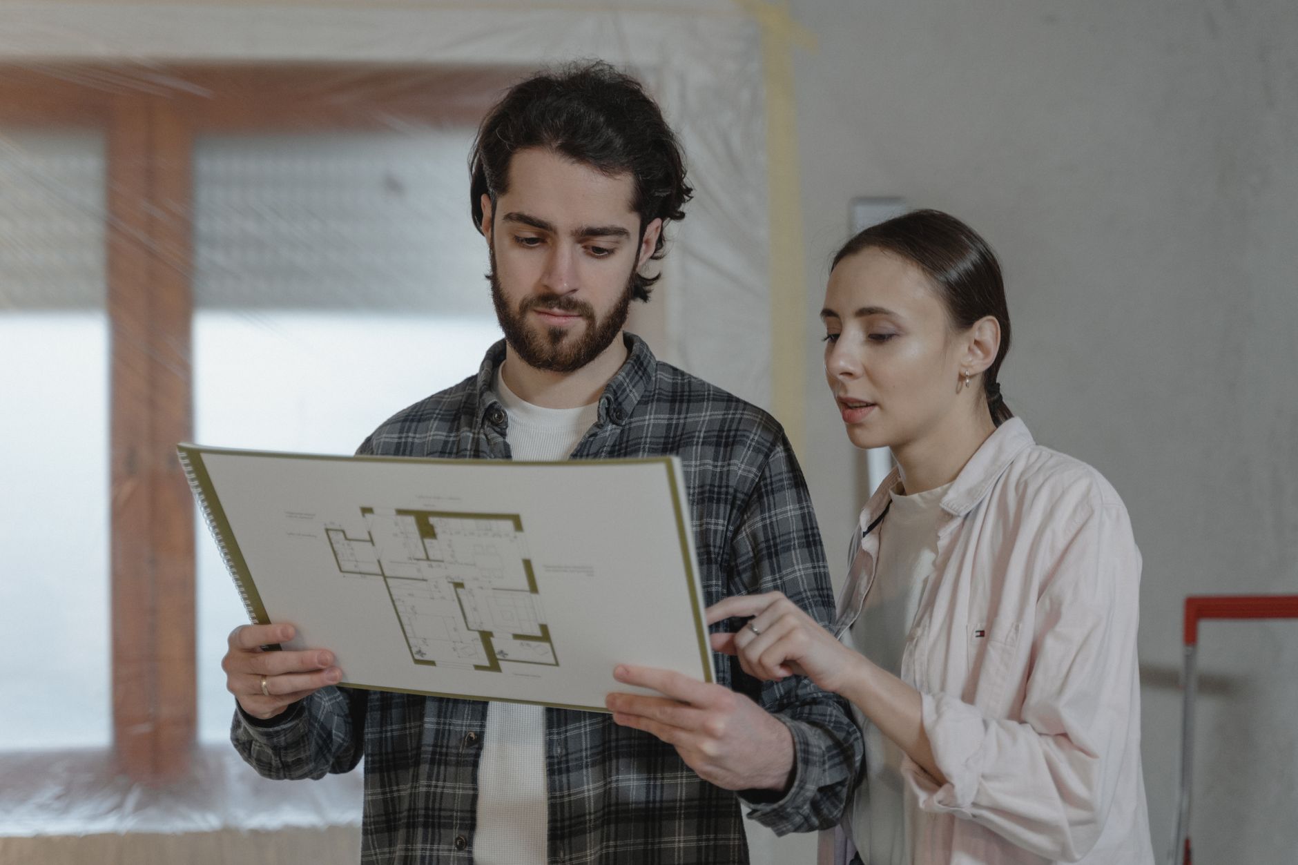 Homeowner reviewing a detailed renovation quote document with a contractor at the table