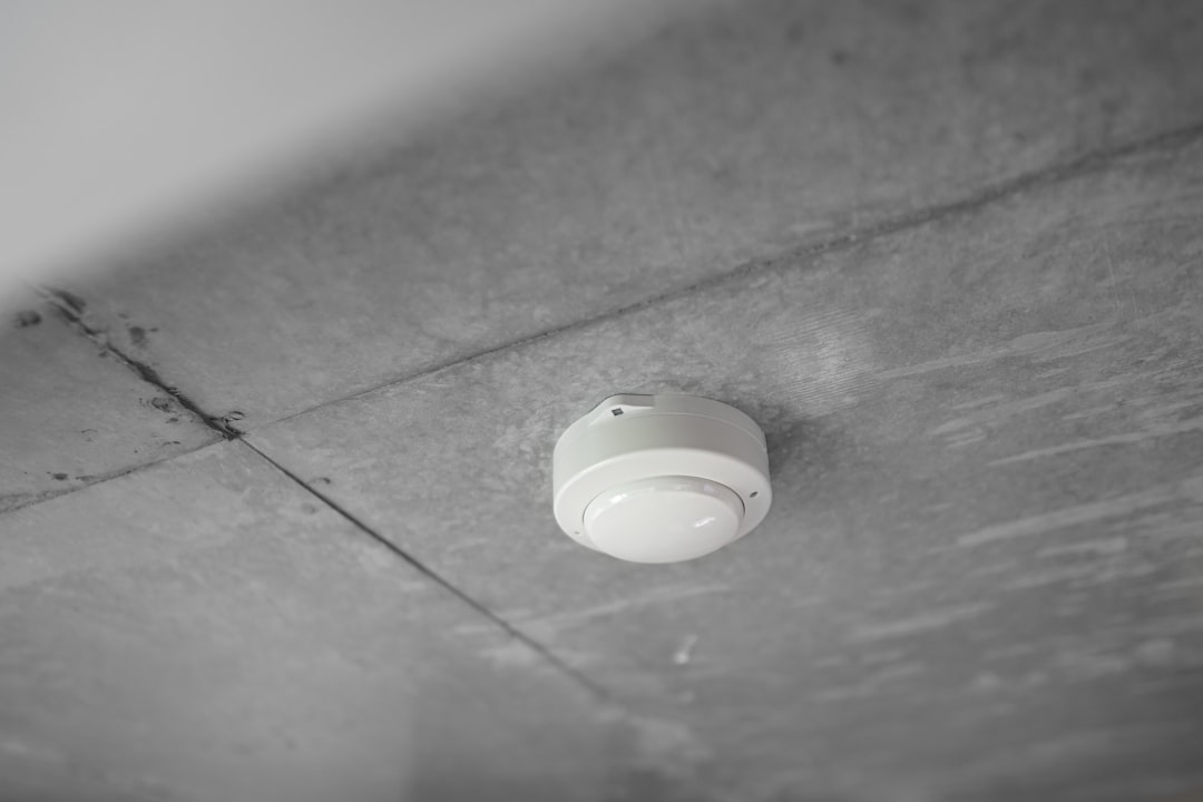 A smoke alarm mounted on a ceiling, ready for a seasonal battery and function check.
