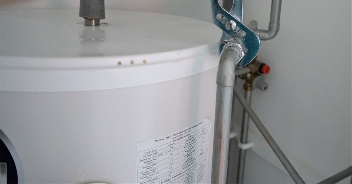 Close-up of a water heater tank connection being fitted during a professional installation