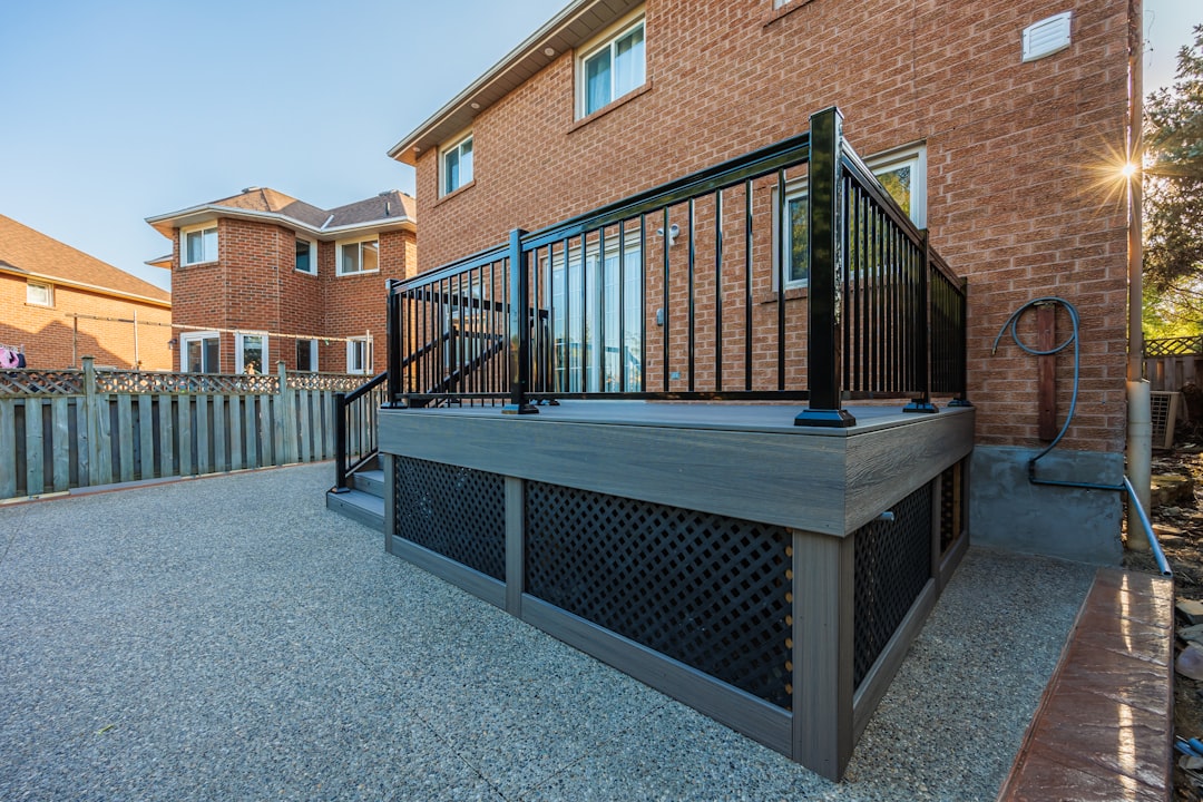 Elevated backyard deck with black aluminum railing and stairs