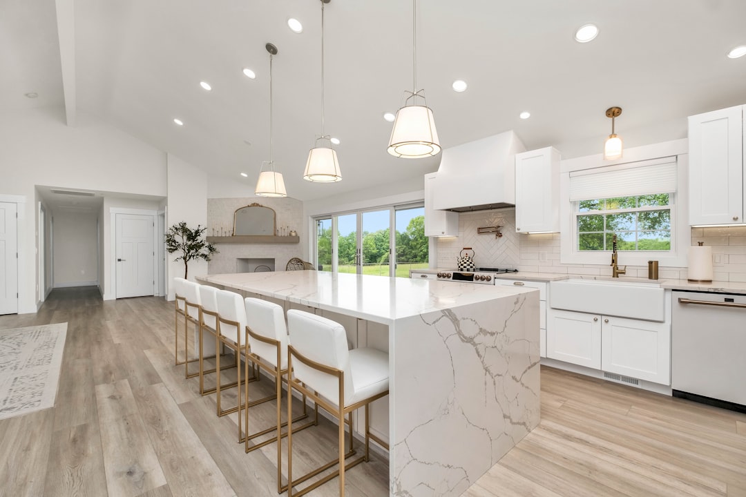 Open-concept kitchen and dining area with new light wood-look flooring